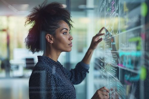 Žena analyzuje data na interaktivní obrazovce.